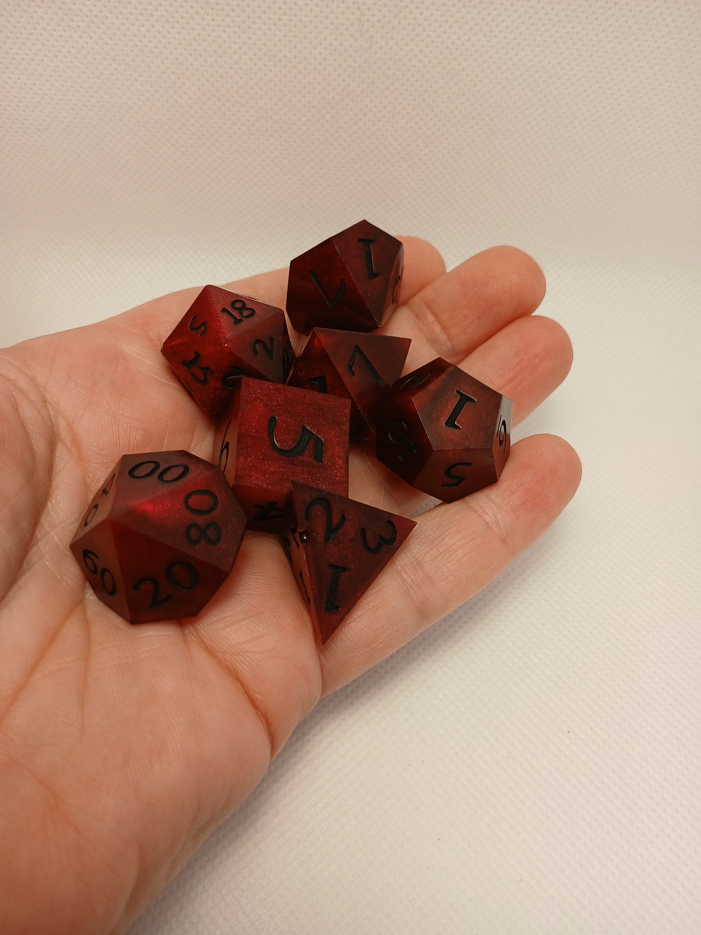 Dice set. Mörk röd med svart siffror.