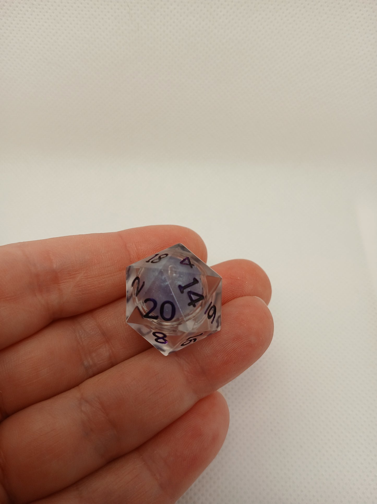 Dice set. Genomskinlig med flytande mitt, lila siffror.