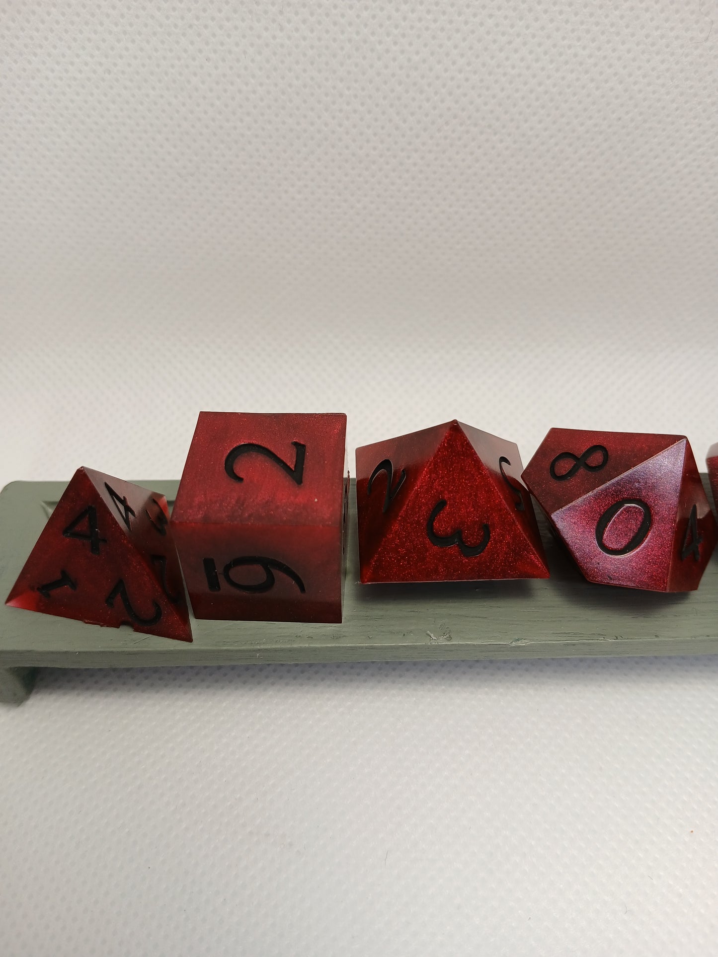 Dice set. Mörk röd med svart siffror.