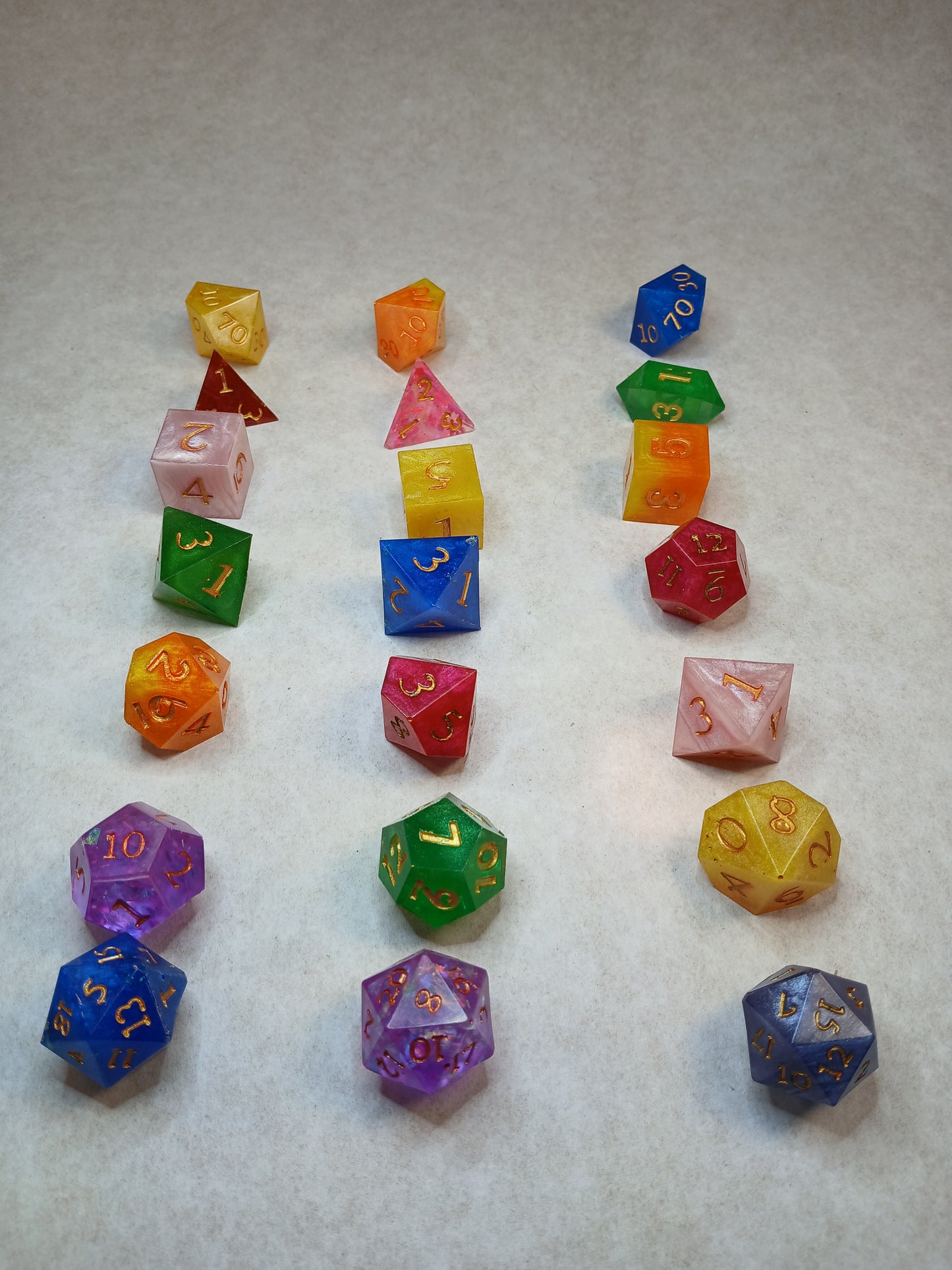 Dice set regnbågsfärger med siffror i guldfärg