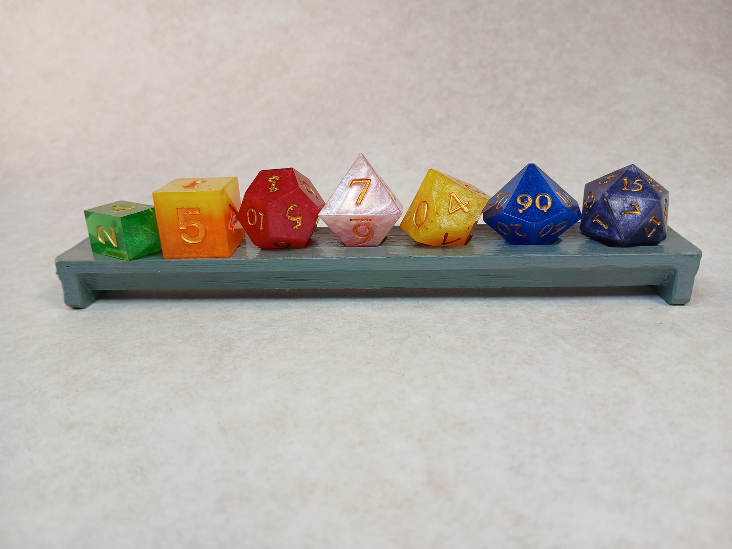 Dice set regnbågsfärger med siffror i guldfärg