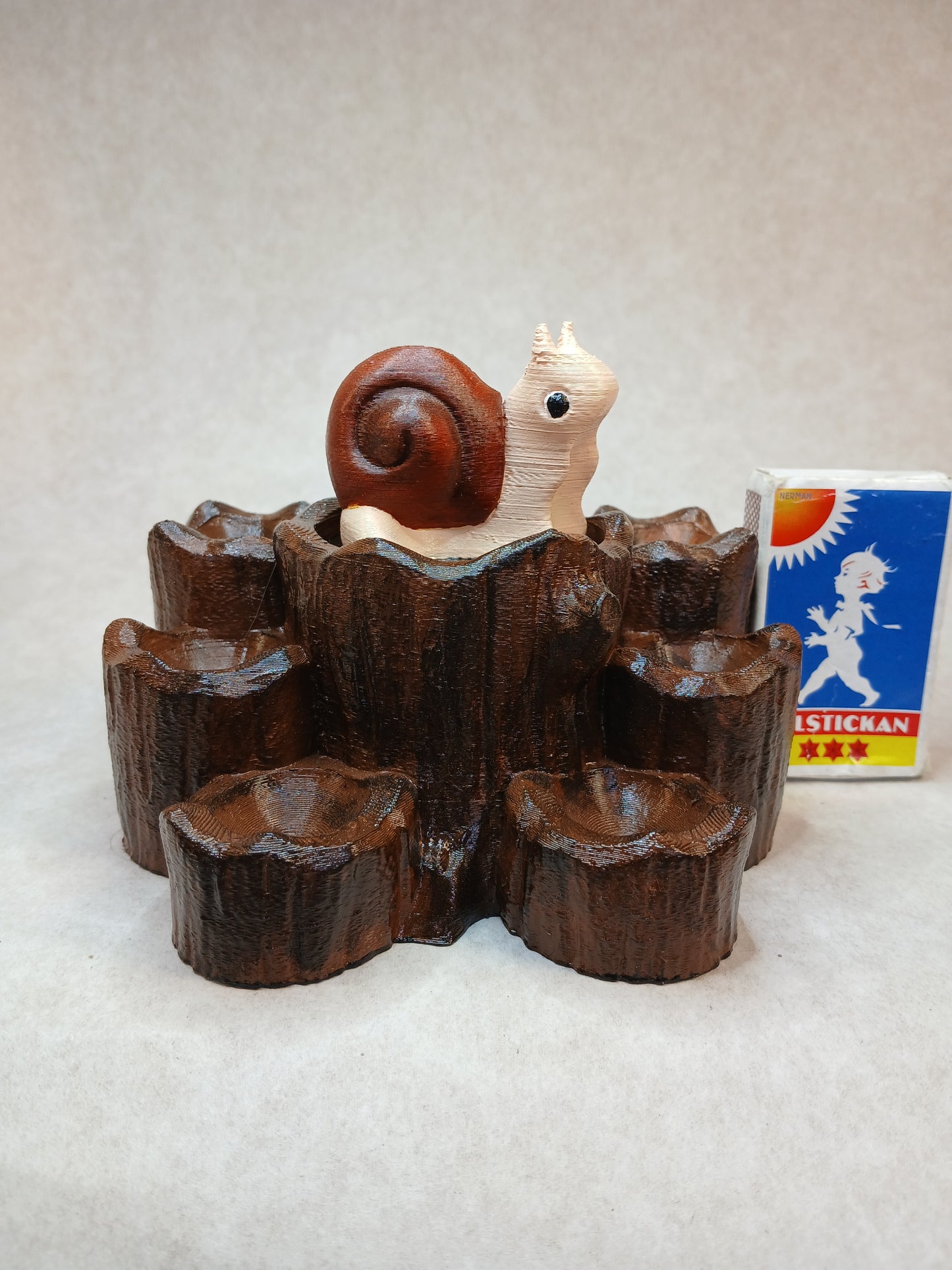 Dice guard and storage Snail on stump.